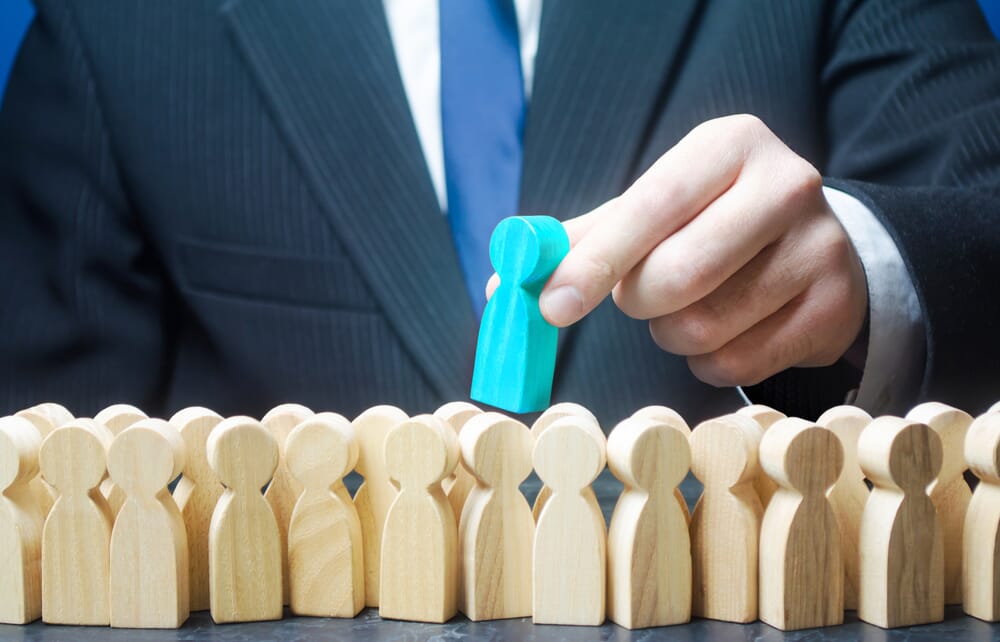 Man-picking-out-a-blue-block-person