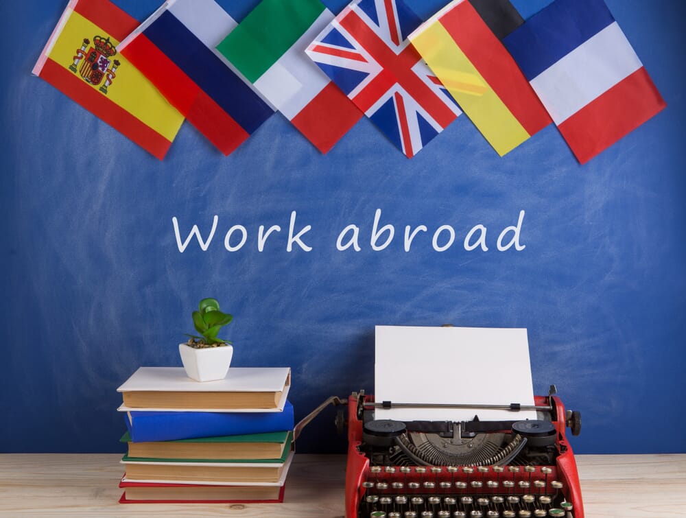 Working-abroad.-flags-books-typewriter
